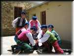 Lajkonik boys in Opoczno costumes around the water pump.